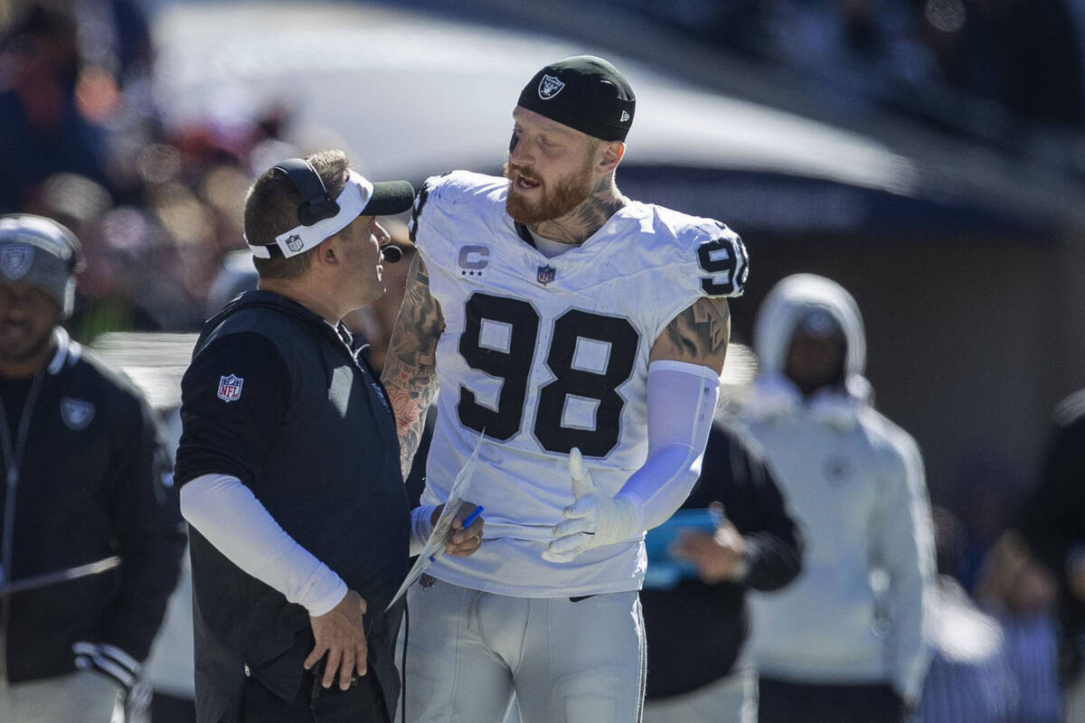 Raiders defensive end Maxx Crosby (98) has engages in an animated discussion with Raiders head ...