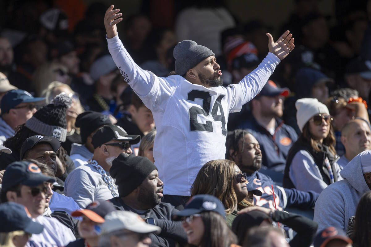 A Raiders fan waves his arms in response to a drive by the team that stalled out during the sec ...