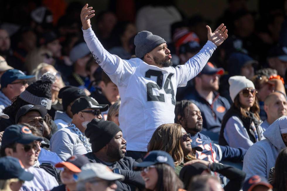 A Raiders fan waves his arms in response to a drive by the team that stalled out during the sec ...