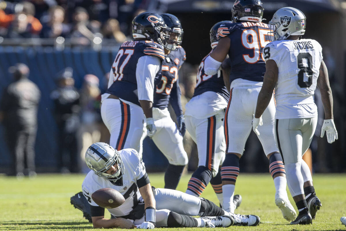 Raiders quarterback Brian Hoyer (7) remains down after being sacked by Chicago Bears defensive ...