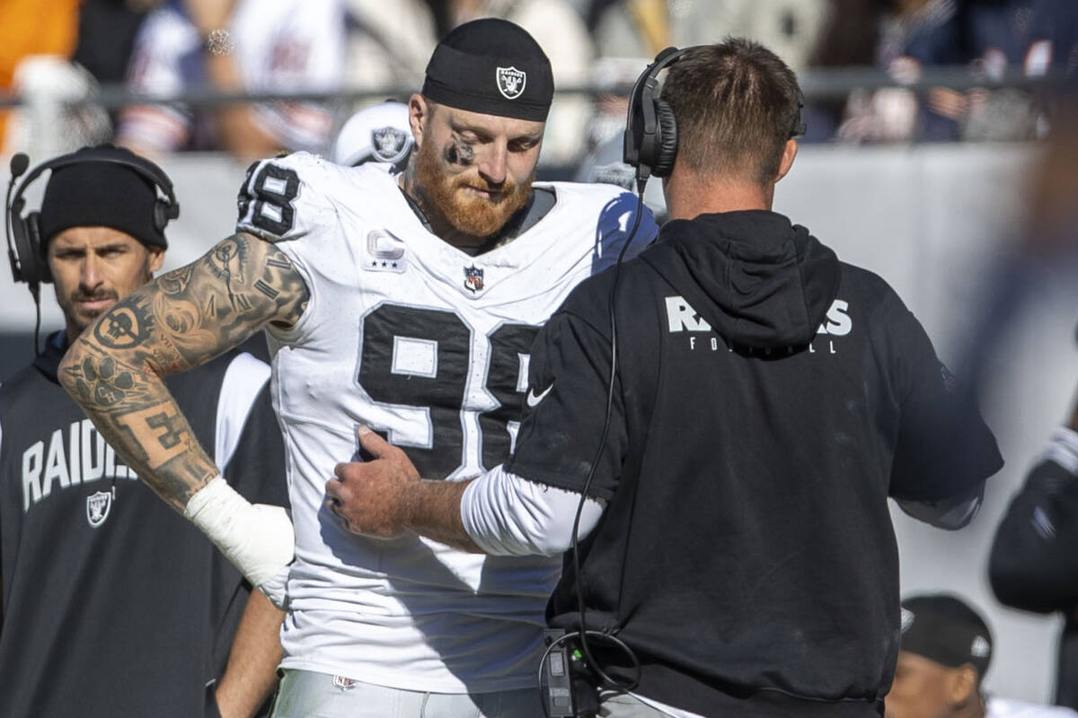 Raiders defensive end Maxx Crosby (98) reacts as a coach speaks to him on the sideline during t ...