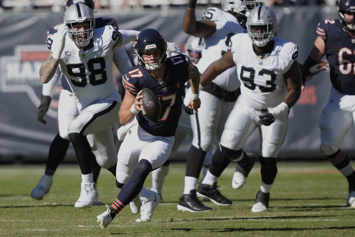 Chicago Bears quarterback Tyson Bagent (17) carries the ball ahead of Las Vegas Raiders defende ...