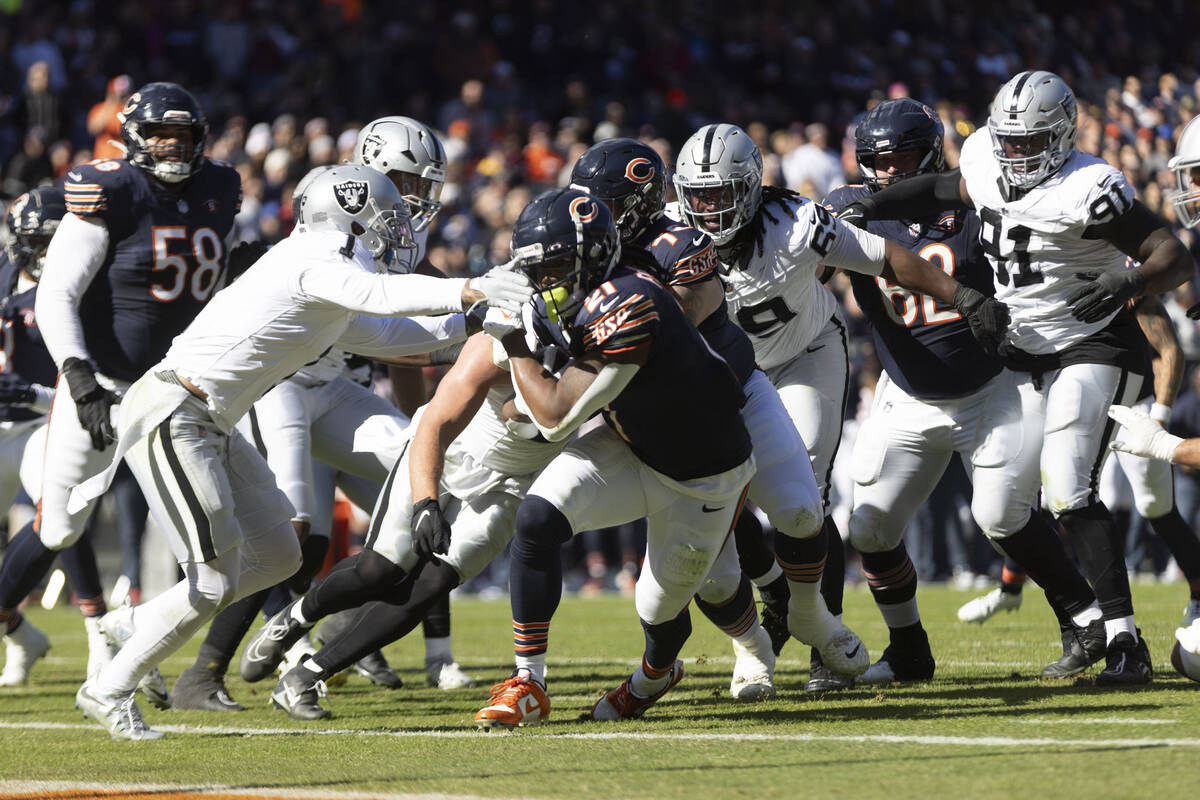 Chicago Bears running back D'Onta Foreman (21) rushes to the end zone with Raiders safety Marcu ...