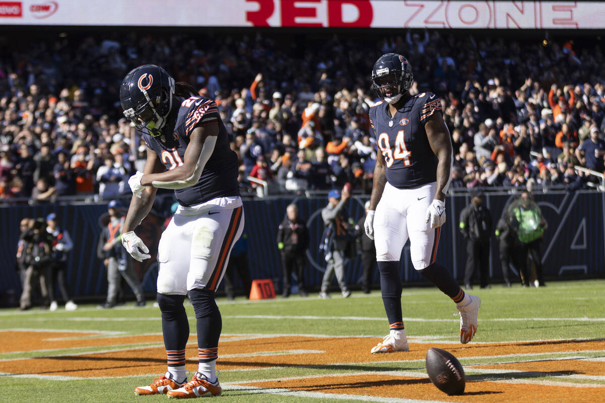 Chicago Bears running back D'Onta Foreman (21) celebrates his touchdown as defensive end Rashee ...