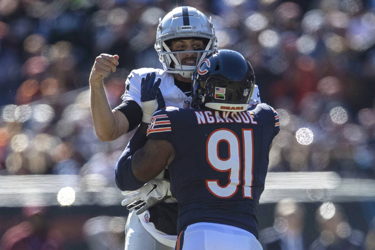 Raiders quarterback Brian Hoyer (7) is pressured by Chicago Bears defensive end Yannick Ngakoue ...