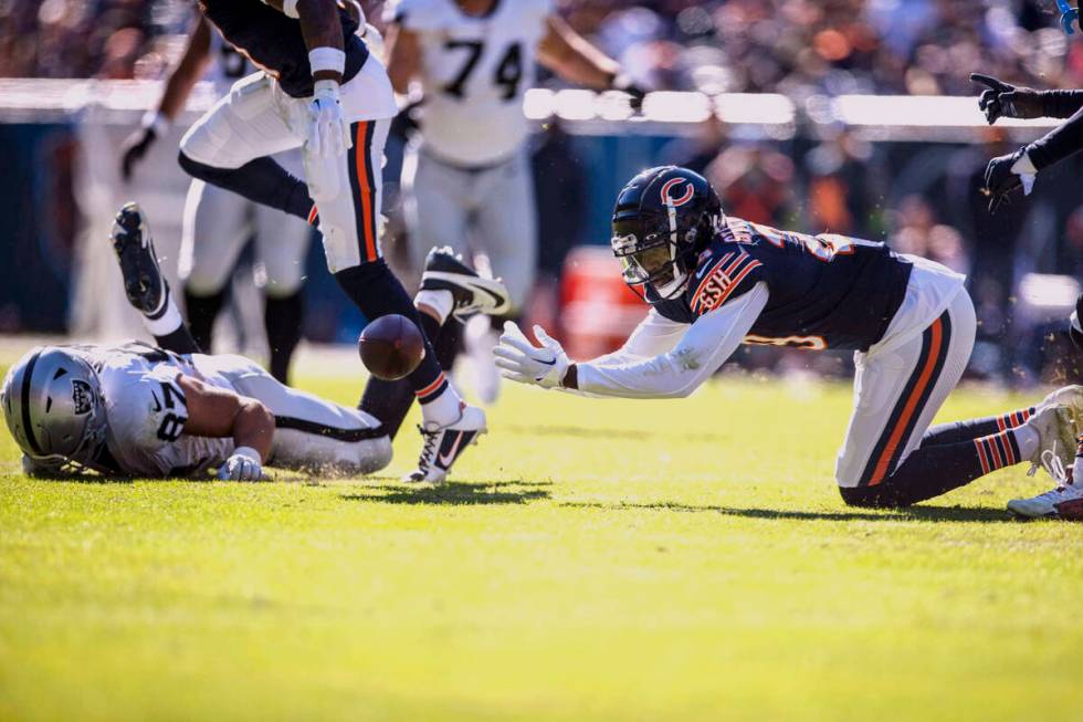 Chicago Bears cornerback Tyrique Stevenson (29) reaches for a pass that Raiders tight end Micha ...