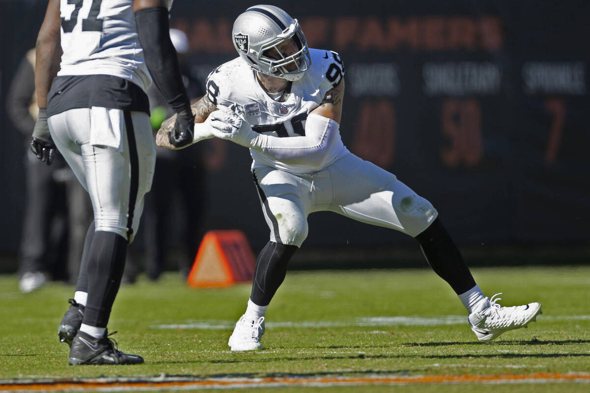 Raiders defensive end Maxx Crosby (98) celebrates his sack of Chicago Bears quarterback Tyson B ...