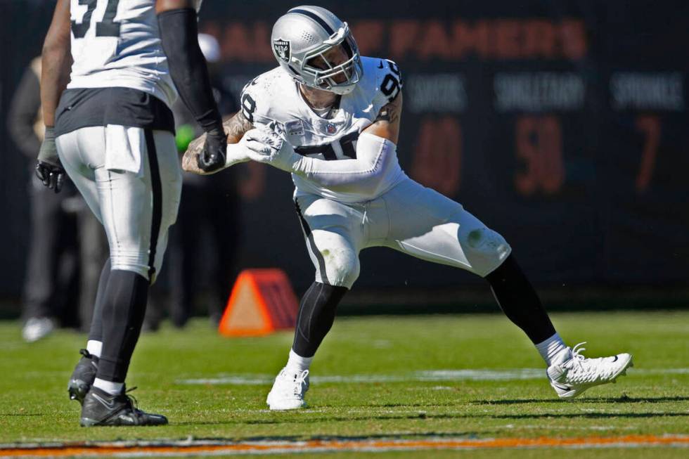 Raiders defensive end Maxx Crosby (98) celebrates his sack of Chicago Bears quarterback Tyson B ...