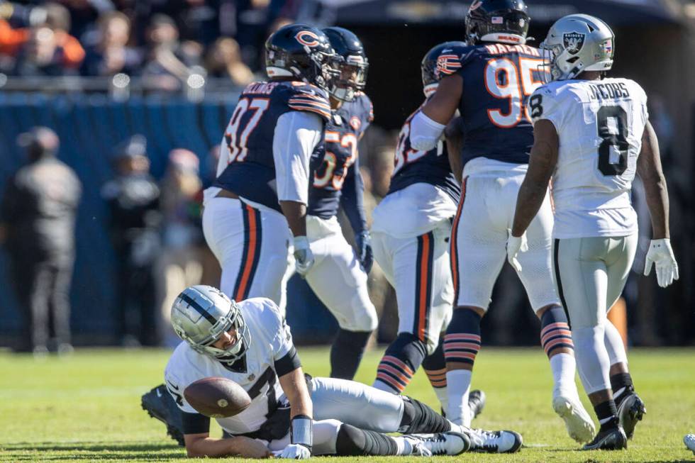 Raiders quarterback Brian Hoyer (7) remains down after being sacked by Chicago Bears defensive ...