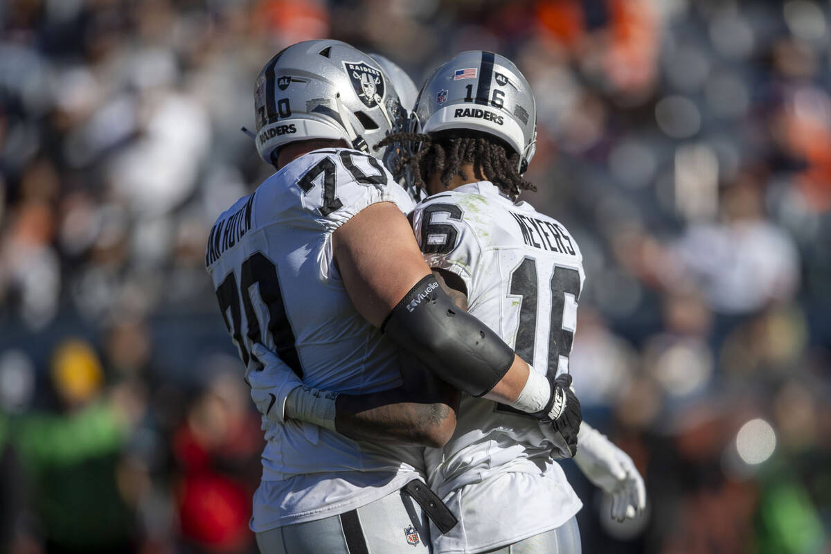 Raiders wide receiver Jakobi Meyers (16) is congratulated by guard Greg Van Roten (70) after sc ...