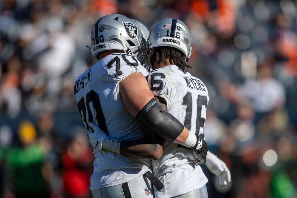 Raiders wide receiver Jakobi Meyers (16) is congratulated by guard Greg Van Roten (70) after sc ...