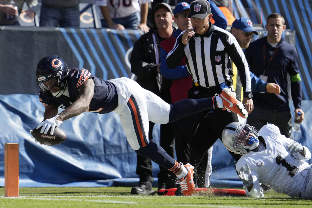 Chicago Bears wide receiver DJ Moore, left, is stopped short of the goal line by Las Vegas Raid ...