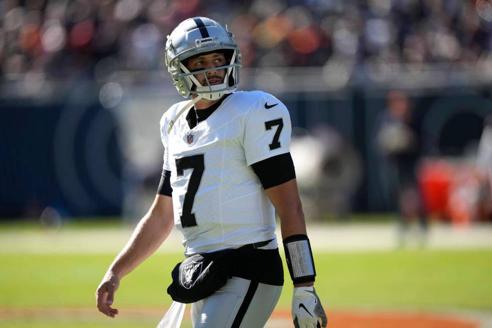 Las Vegas Raiders quarterback Brian Hoyer looks at the scoreboard as he walks to the sideline i ...