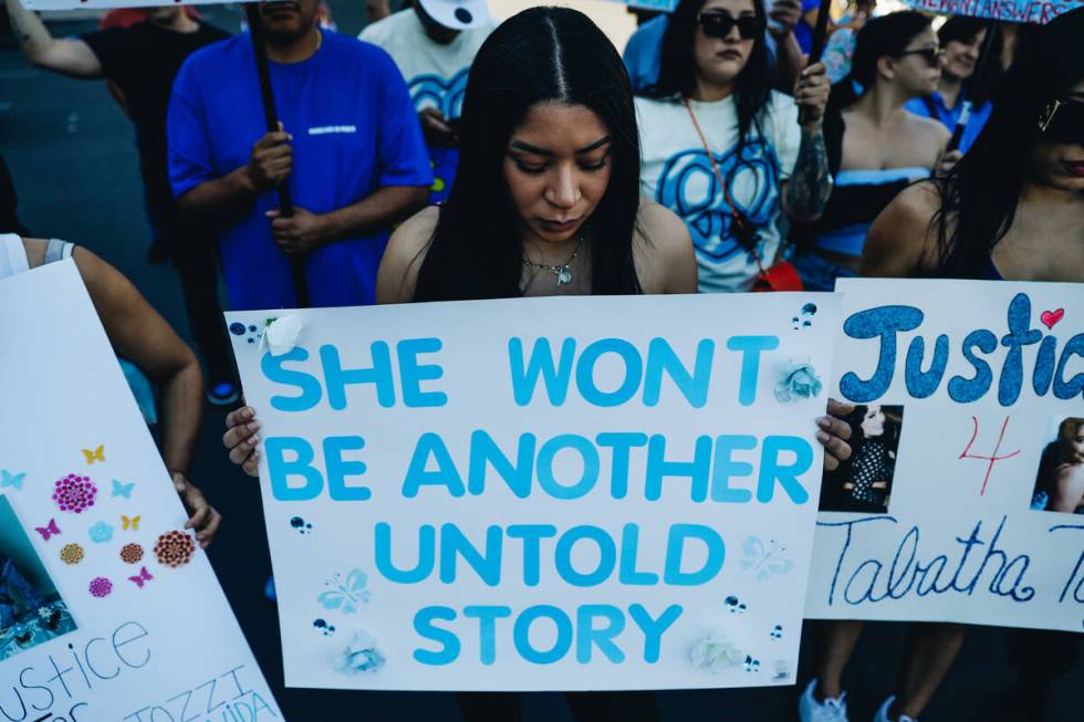 A mourner holds up a sign during a demonstration in memory of Tabatha Tozzi at Metropolitan Pol ...