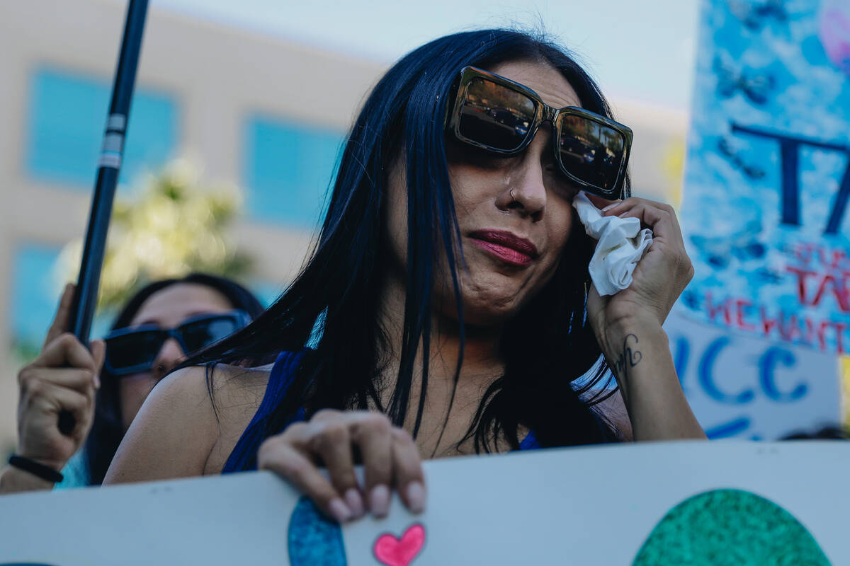 A mourner cries as they hold up a sign during a demonstration in memory of Tabatha Tozzi at Met ...