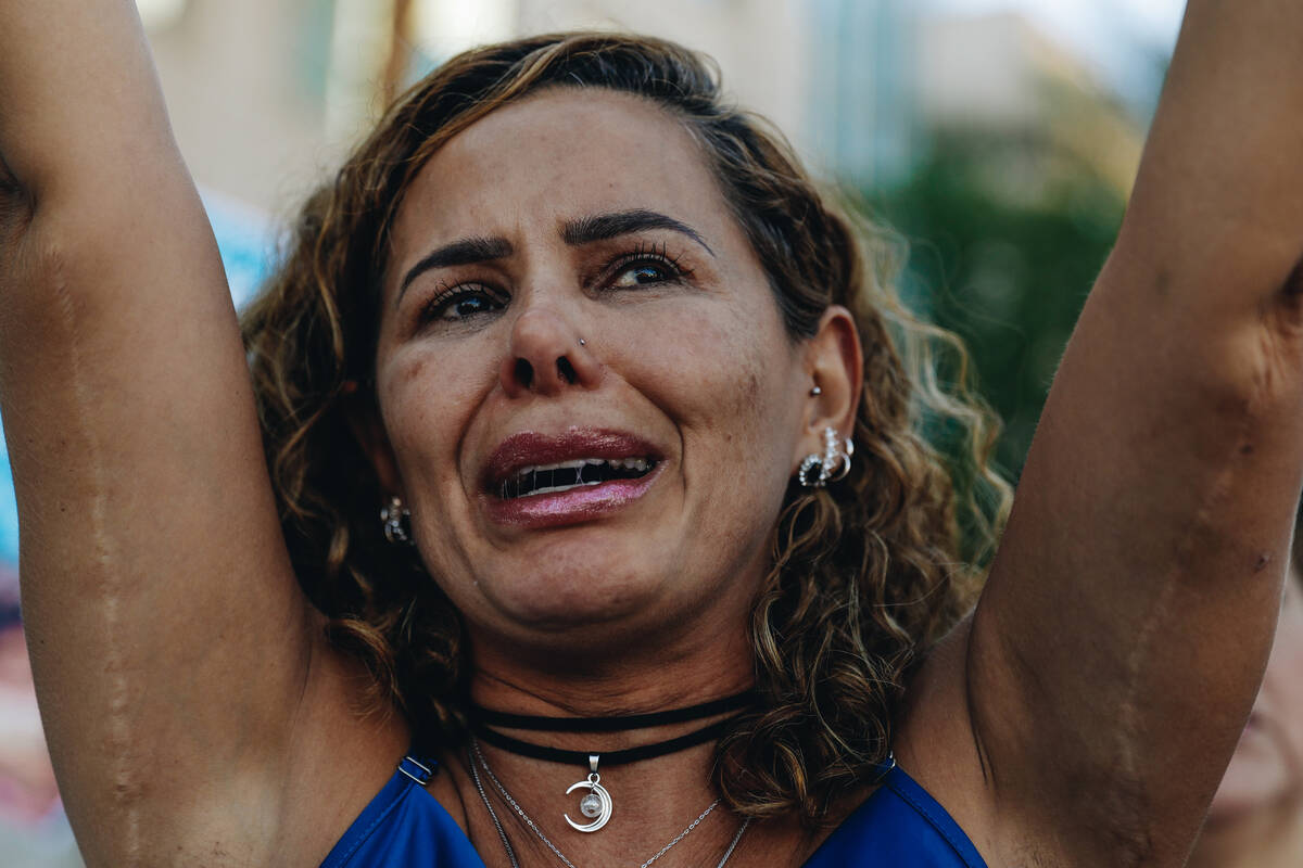 A mourner cries as they hold up a sign during a demonstration in memory of Tabatha Tozzi at Met ...