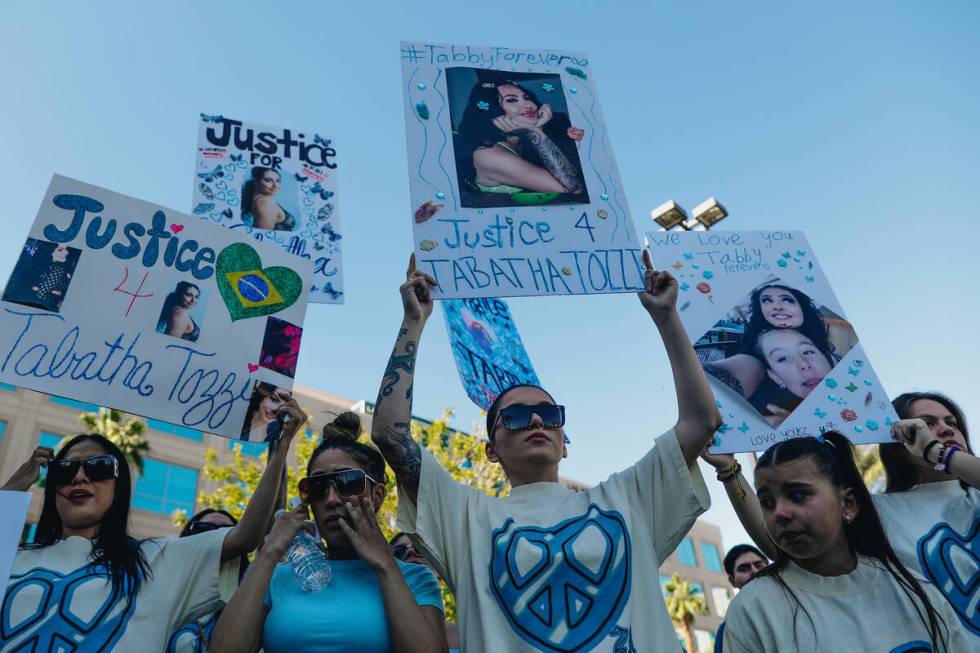 Protesters hold up signs during a demonstration in memory of Tabatha Tozzi at Metropolitan Poli ...