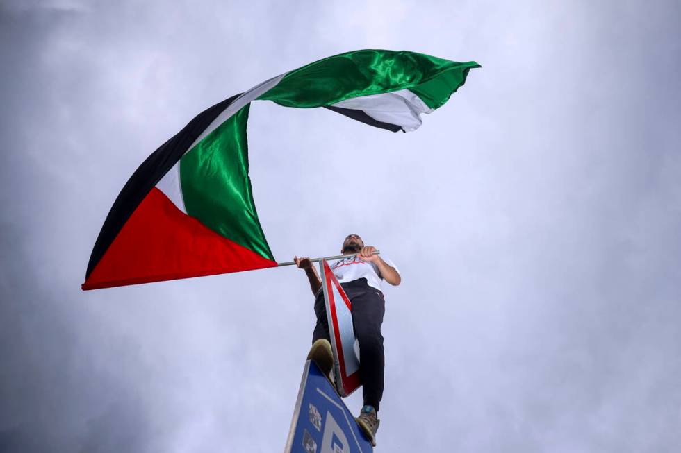 A Bosnian man waves a Palestinian flag during a protest against Israel and in support of Palest ...