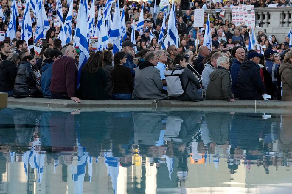 Israeli supports show placards with the faces and names of people believed to be taken hostage ...