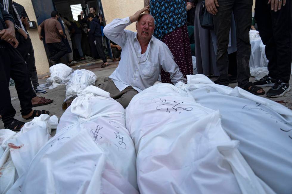 Palestinians mourn their relatives killed in the Israeli bombardment of the Gaza Strip at Al-Aq ...