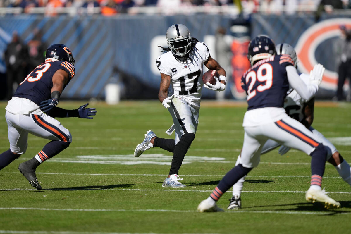 Las Vegas Raiders wide receiver Davante Adams (17) carries the ball against the Chicago Bears i ...