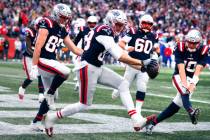 New England Patriots tight end Mike Gesicki, center, celebrates with teammates after his touchd ...