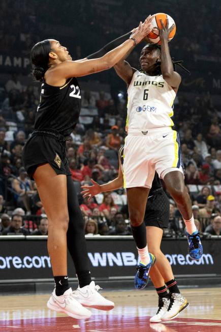 Dallas Wings forward Natasha Howard (6) shoots while Las Vegas Aces forward A'ja Wilson (22) bl ...