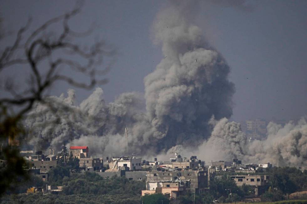 Smoke rises following an Israeli airstrike in the Gaza Strip, as seen from southern Israel, Mon ...