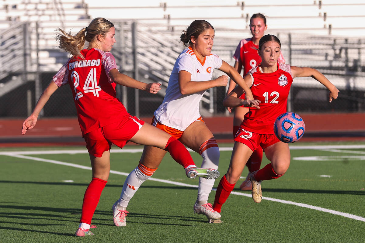 Bishop Gorman and Coronado players fight for the ball during a soccer game between Coronado Hig ...