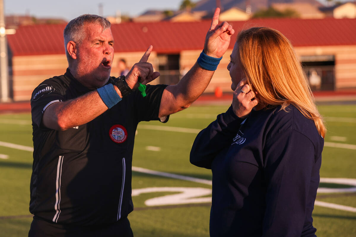 A referee speaks to Coronado’s assistant principal during a soccer game between Coronado High ...