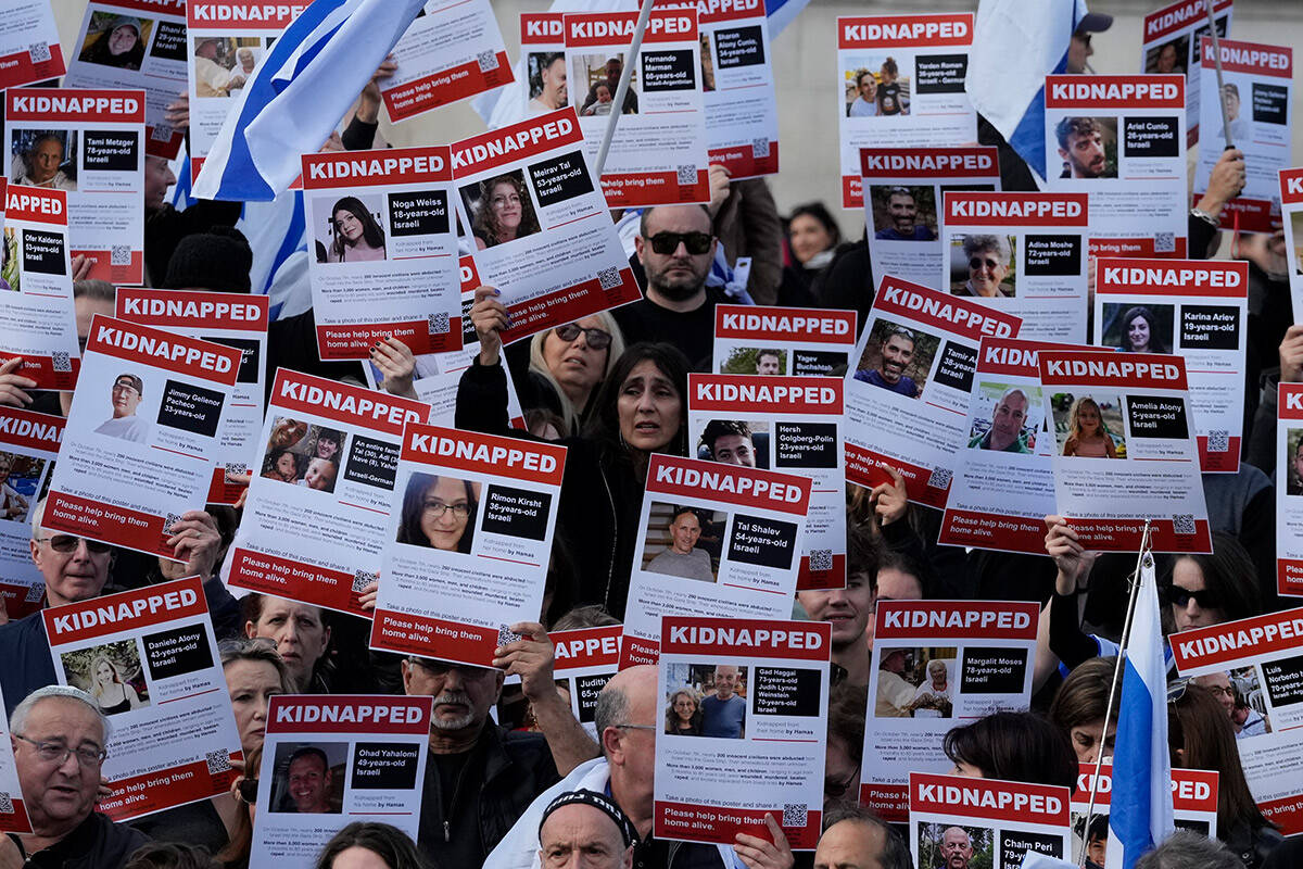 Israeli supports show placards with the faces and names of people believed to be taken hostage ...