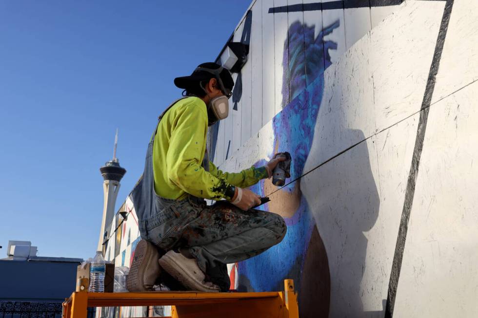 Artist Juan Ochoa paints a mural honoring the WNBA champion Aces on Main Street north of Imperi ...