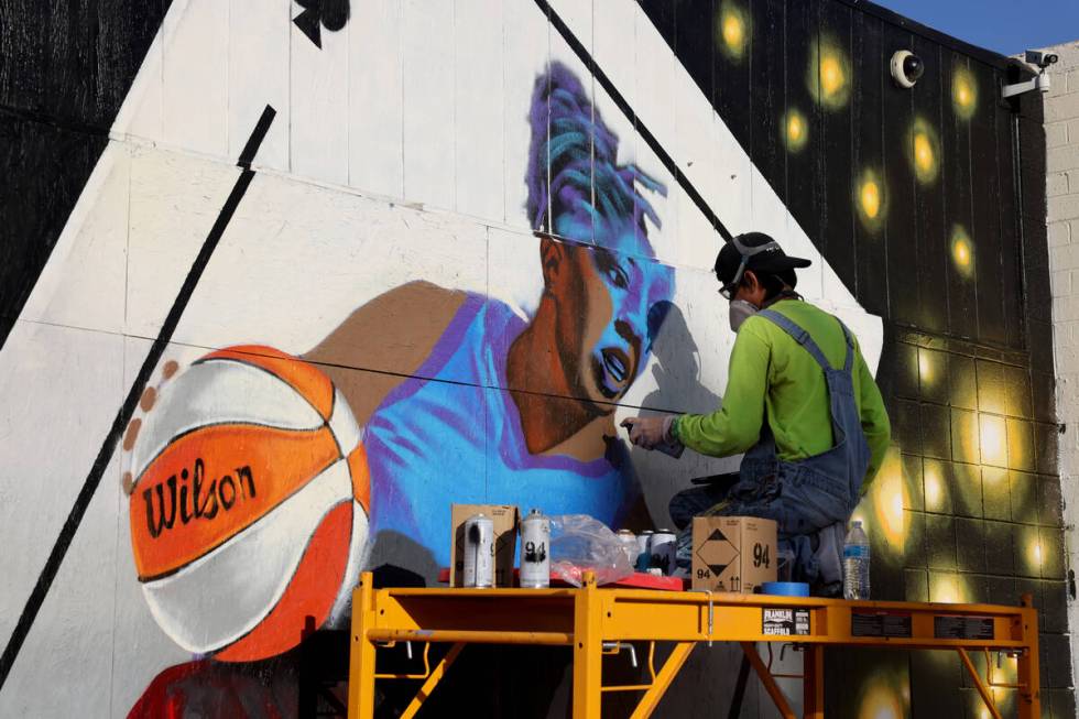 Artist Juan Ochoa paints a mural honoring the WNBA champion Aces on Main Street north of Imperi ...