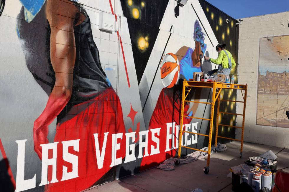 Artist Juan Ochoa paints a mural honoring the WNBA champion Aces on Main Street north of Imperi ...