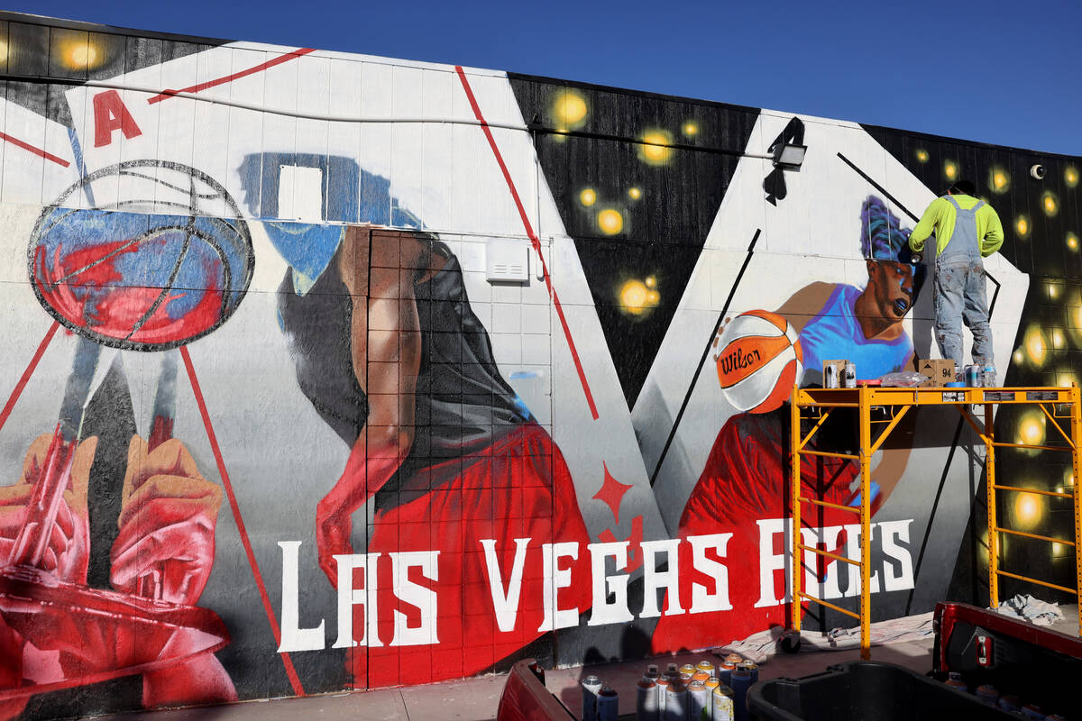 Artist Juan Ochoa paints a mural honoring the WNBA champion Aces on Main Street north of Imperi ...