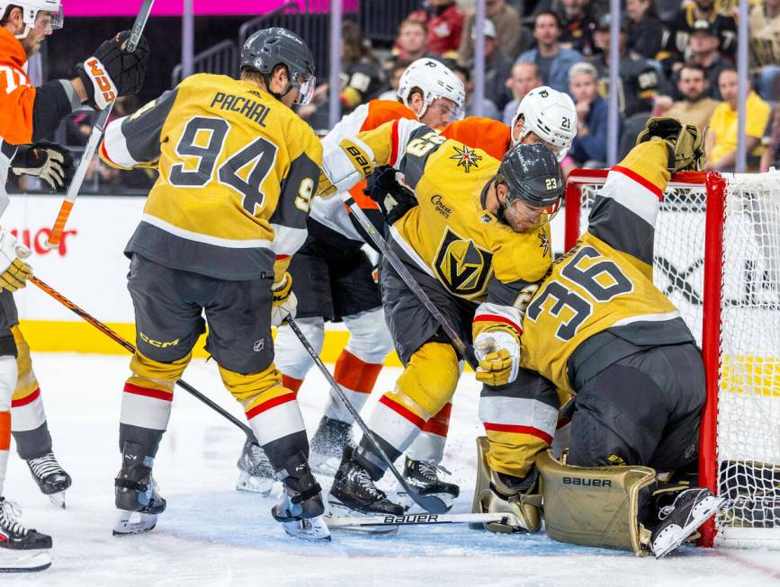 Golden Knights goaltender Logan Thompson (36) smothers a shot from Philadelphia Flyers center S ...