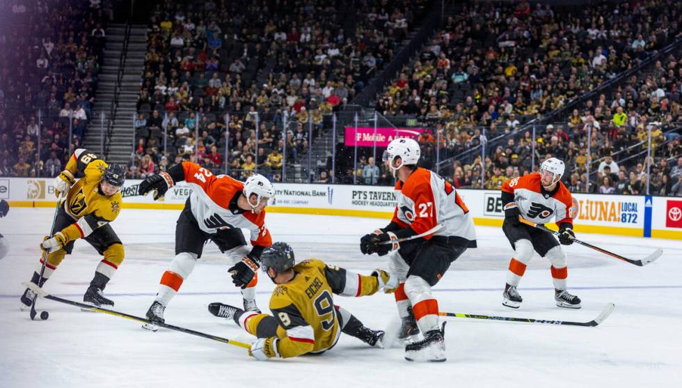 Golden Knights center Ivan Barbashev (49) controls the puck as teammate center Jack Eichel (9) ...