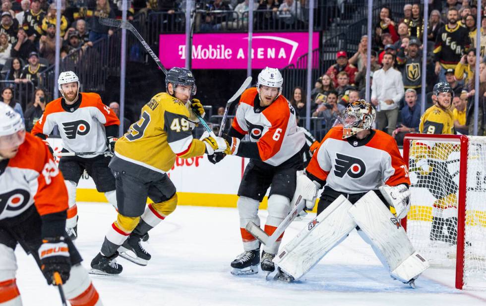 Golden Knights center Ivan Barbashev (49) and Philadelphia Flyers defenseman Travis Sanheim (6) ...