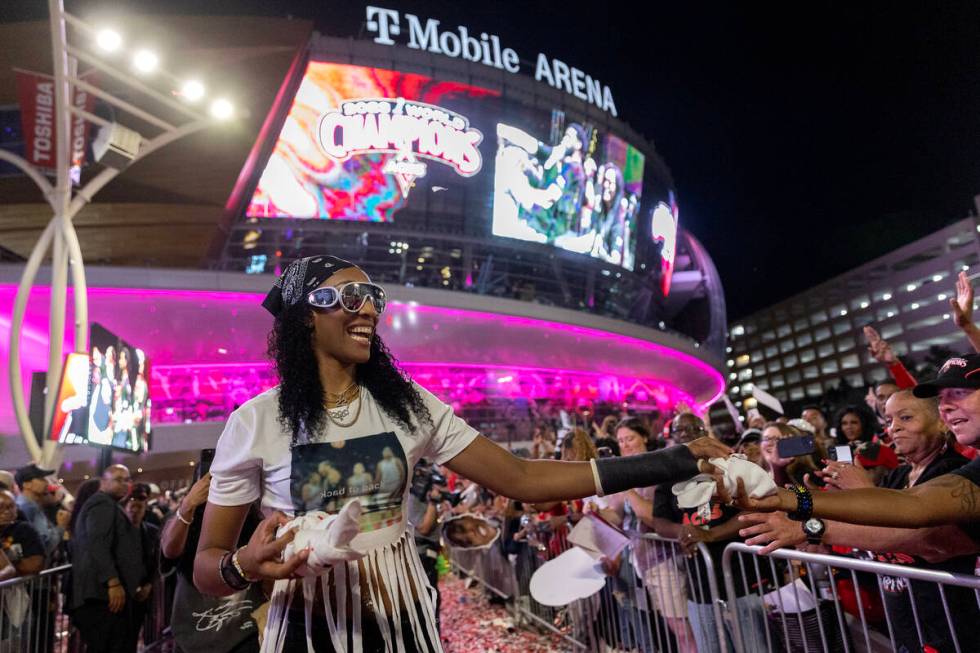Las Vegas Aces forward A'ja Wilson (22) hands out t-shirts to fans during a celebration of the ...