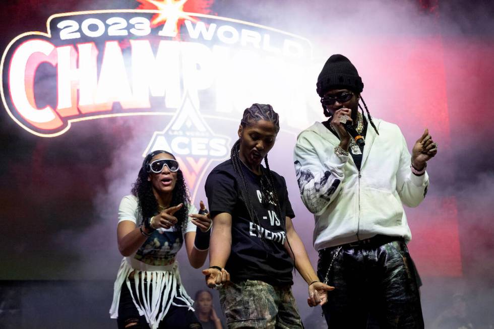 Las Vegas Aces forward A'ja Wilson, left, and guard Kierstan Bell dance on stage with 2Chainz p ...