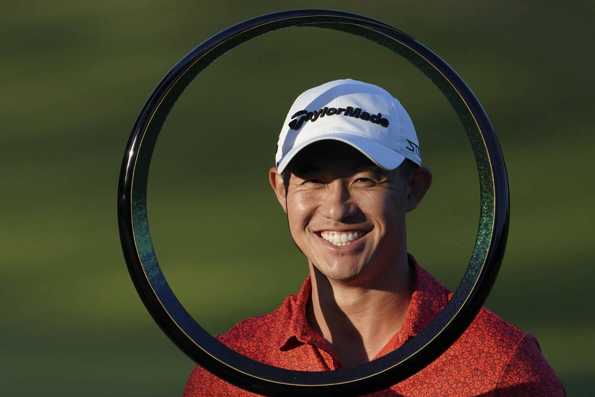 Collin Morikawa of the United States poses with the trophy after winning the PGA Tour Zozo Cham ...