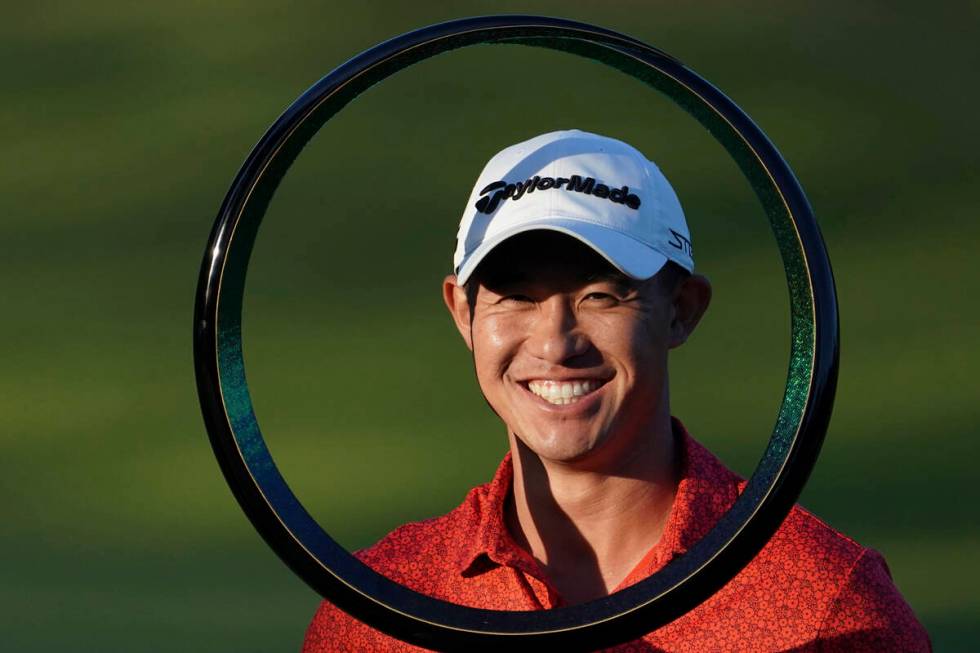 Collin Morikawa of the United States poses with the trophy after winning the PGA Tour Zozo Cham ...