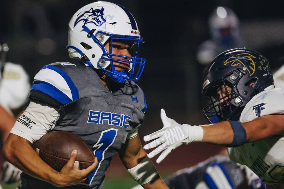 Basic quarterback Anthony Vega (1) runs the ball past a Foothill defender during a game at Basi ...