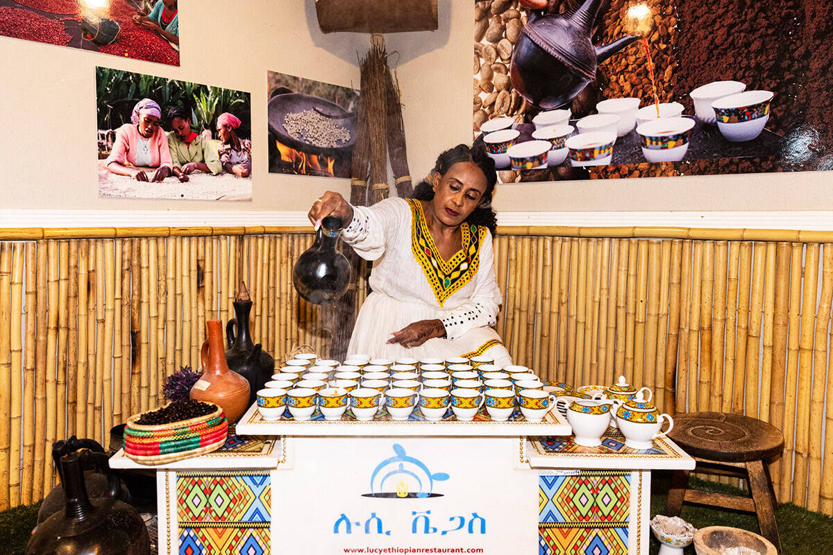 Aster Yoseph pours roasted coffee, prepared in a traditional Ethiopian ceremony, at Lucy Ethiop ...