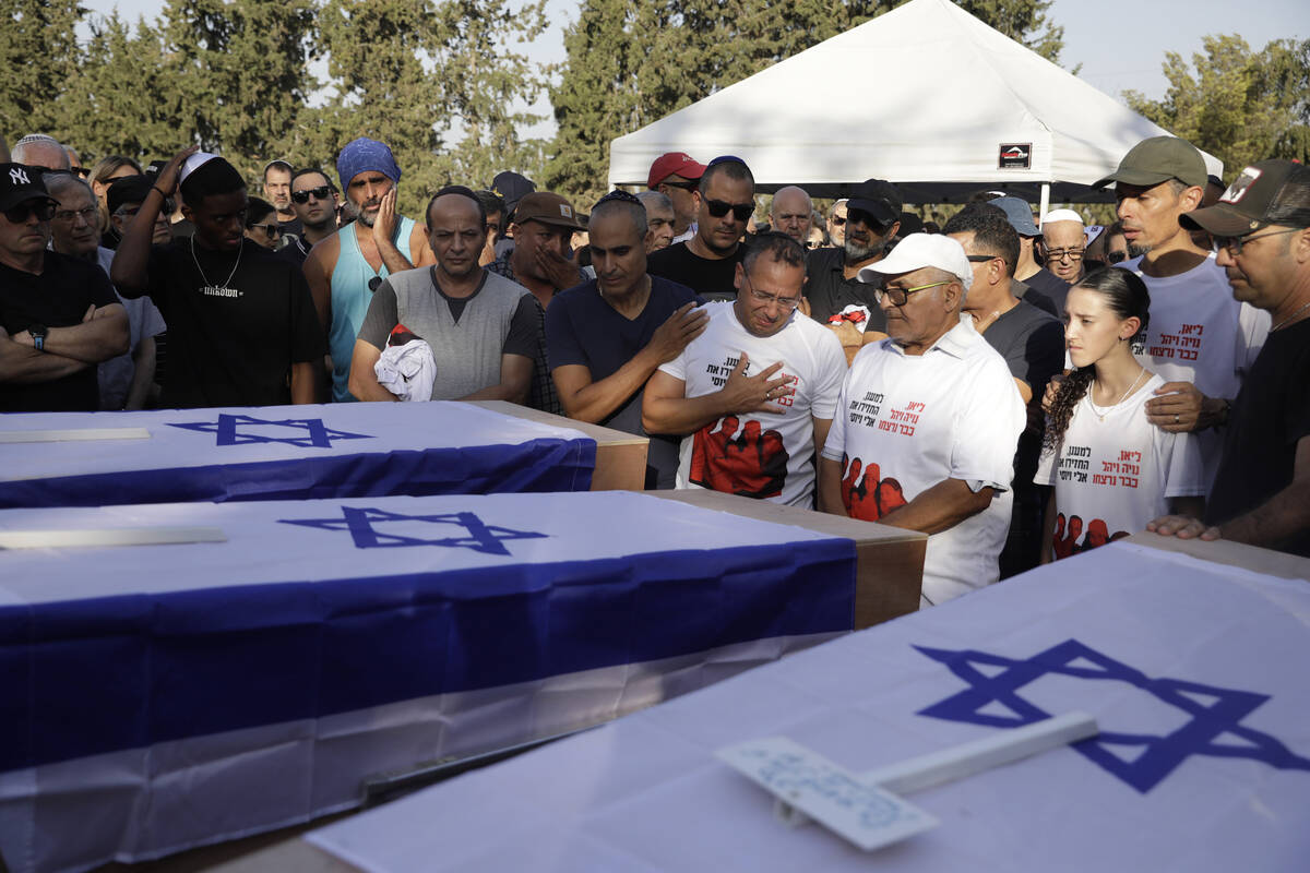 Mourners attend the funeral for members of the Sharabi family, who were killed in the attack on ...