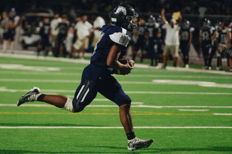 Shadow Ridge quarterback Coen Coloma (8) runs with the ball for a touchdown during a game again ...