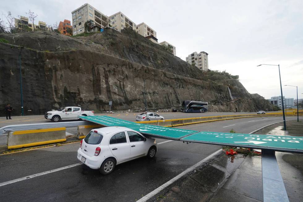 A traffic sign lays on a car after Hurricane Otis ripped through Acapulco, Mexico, Wednesday, O ...