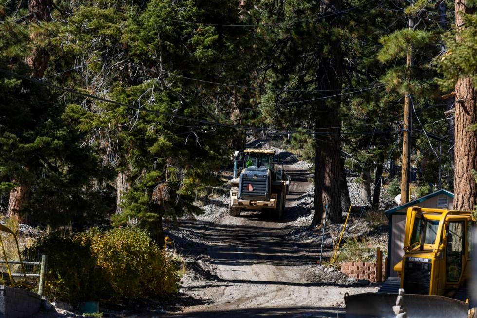 A construction vehicle makes its way up a road in Old Town as repairs continue at Mount Charles ...