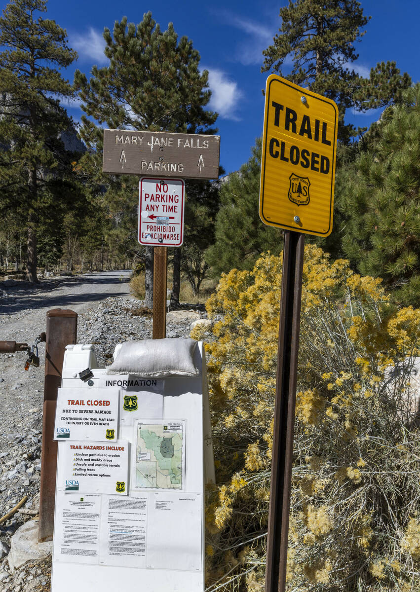 Signs stating that the Mary Jane Falls Trail is closed from the Trail Canyon parking lot as rep ...