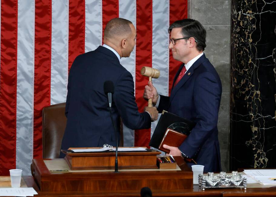 House Minority Leader Hakeem Jeffries, D-N.Y., left, hands the gavel to newly elected Speaker o ...